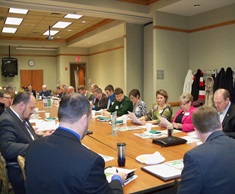 board members in a meeting sitting a long table