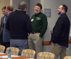 board members standing and laughing